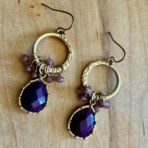 Purple and gold-colored hook earrings with small light purple beads.